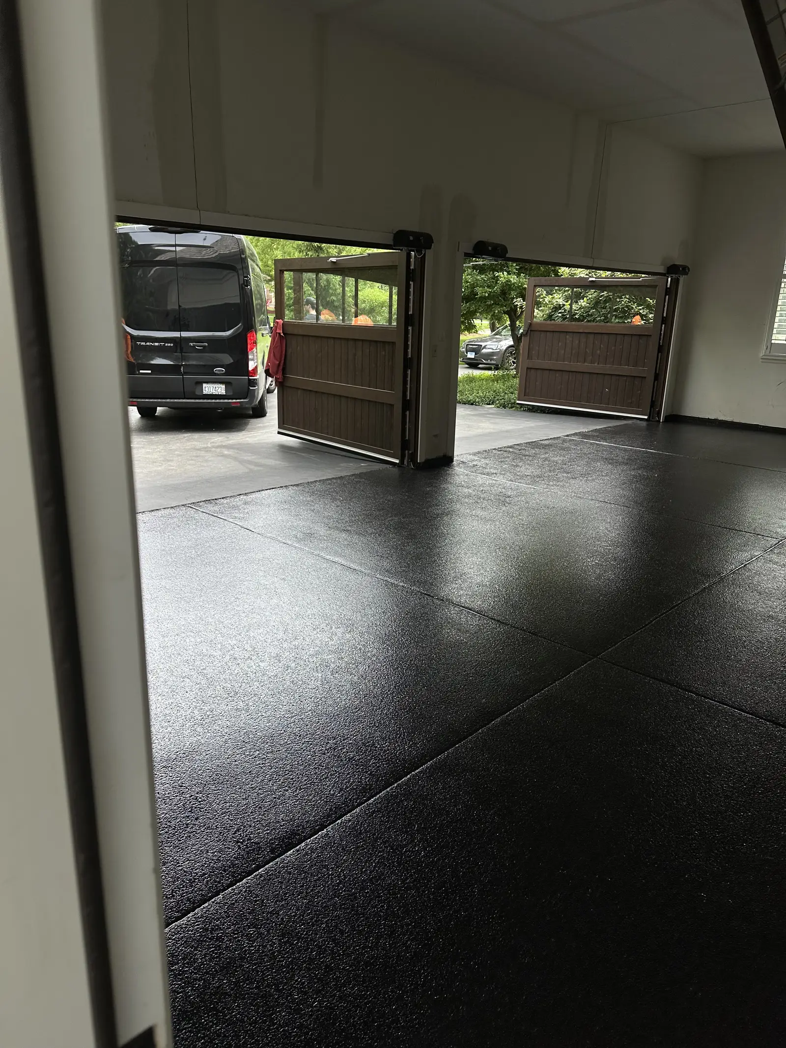 Black flake coated garage floor with both garage doors standing open