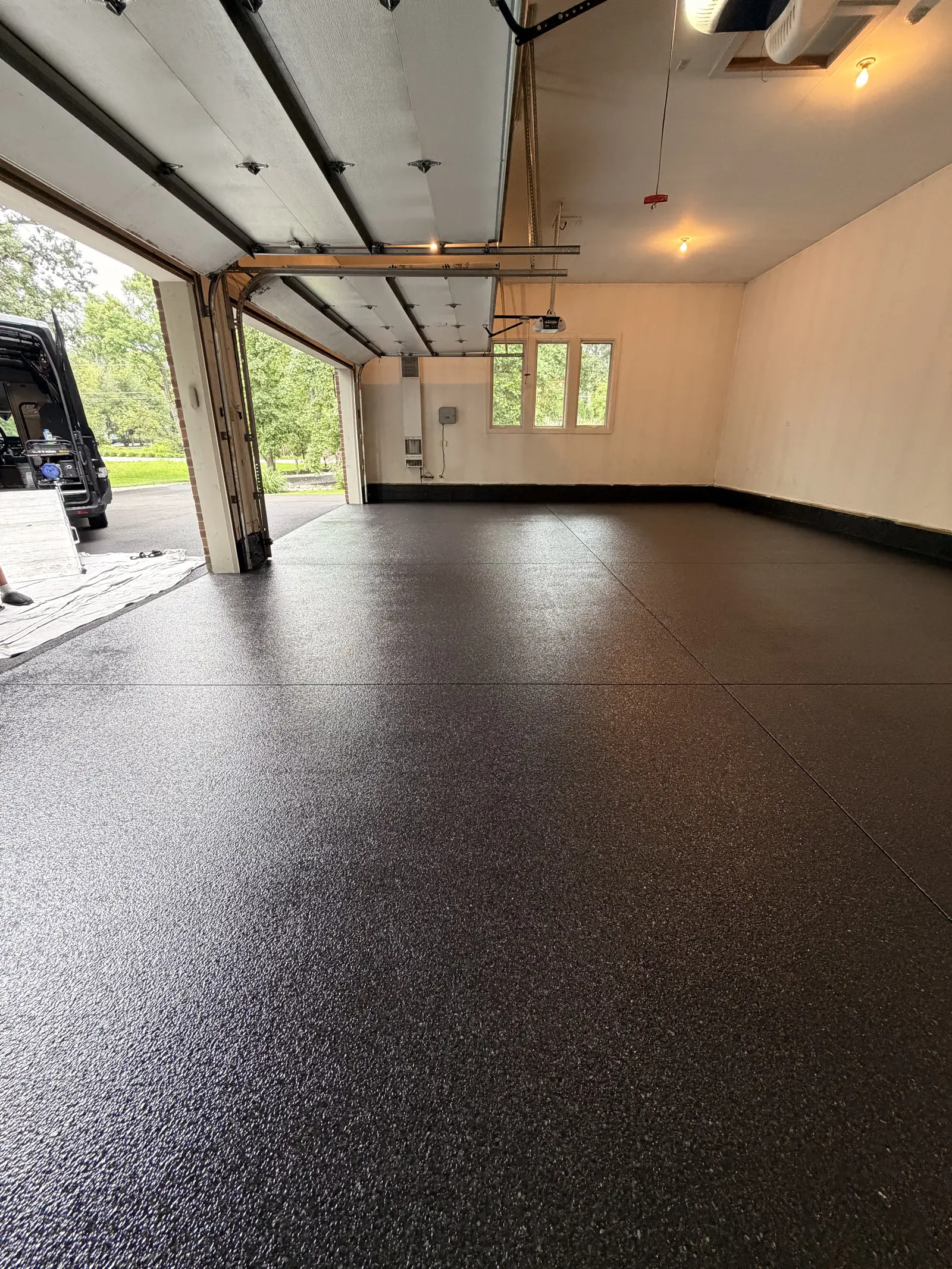 Dark flake coated garage floor sweeping out to the open garage door