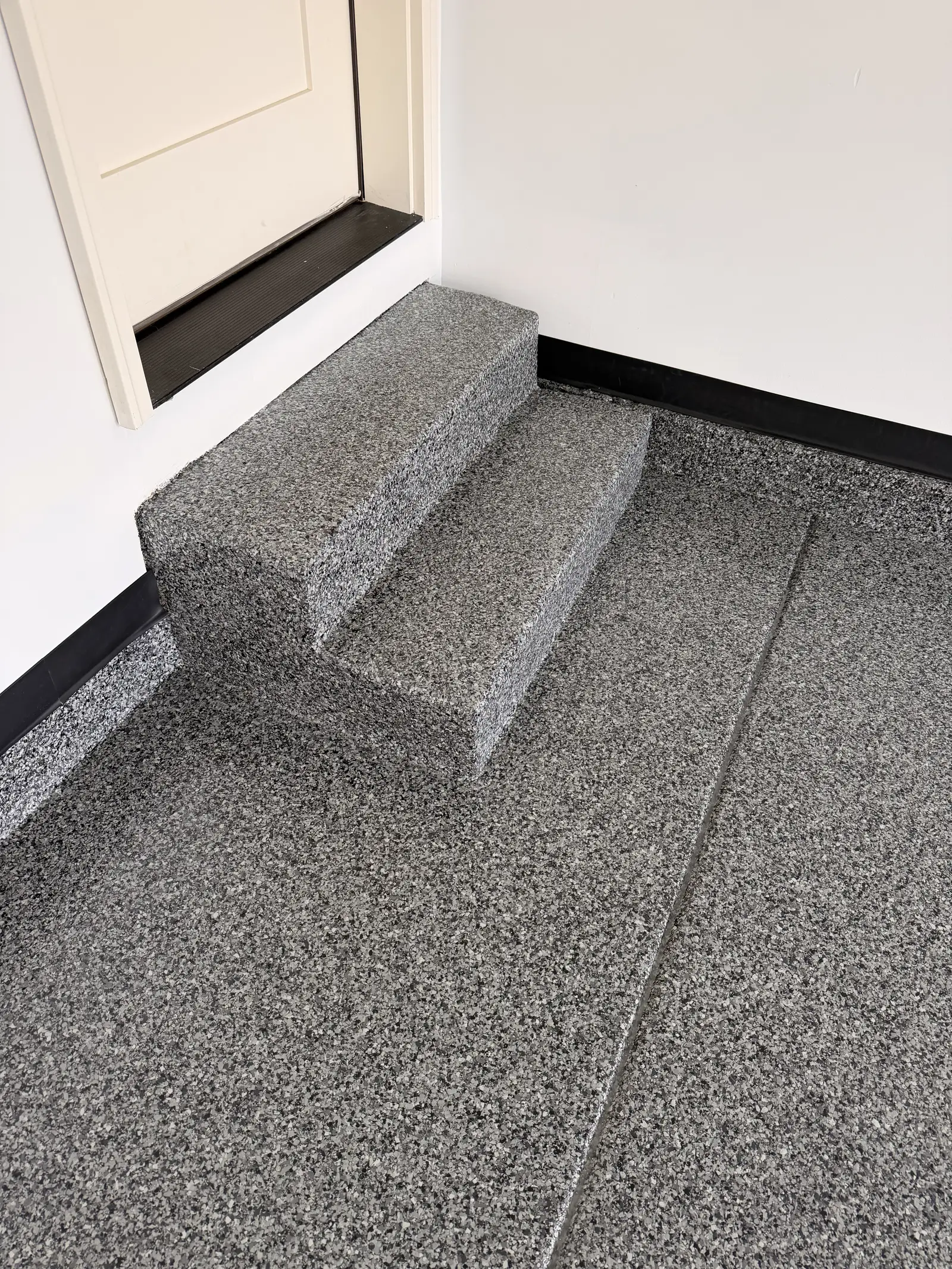 Flake coated garage steps finished to match the floor