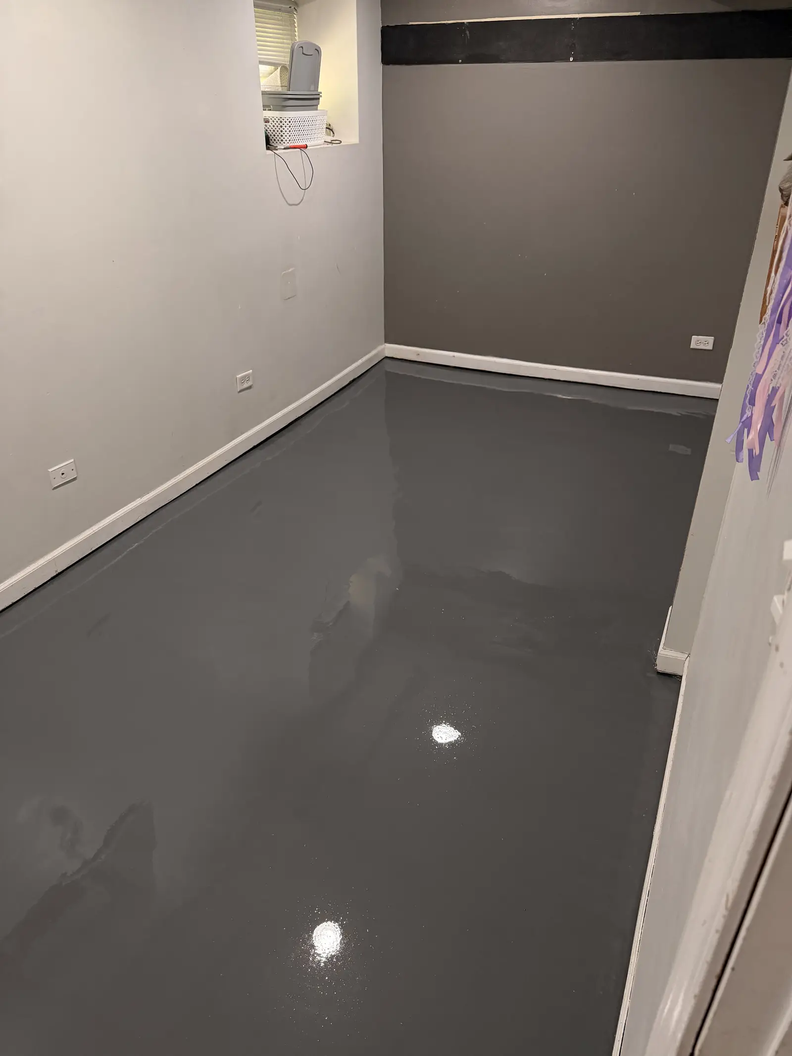 Grey metallic floor finished through a basement room
