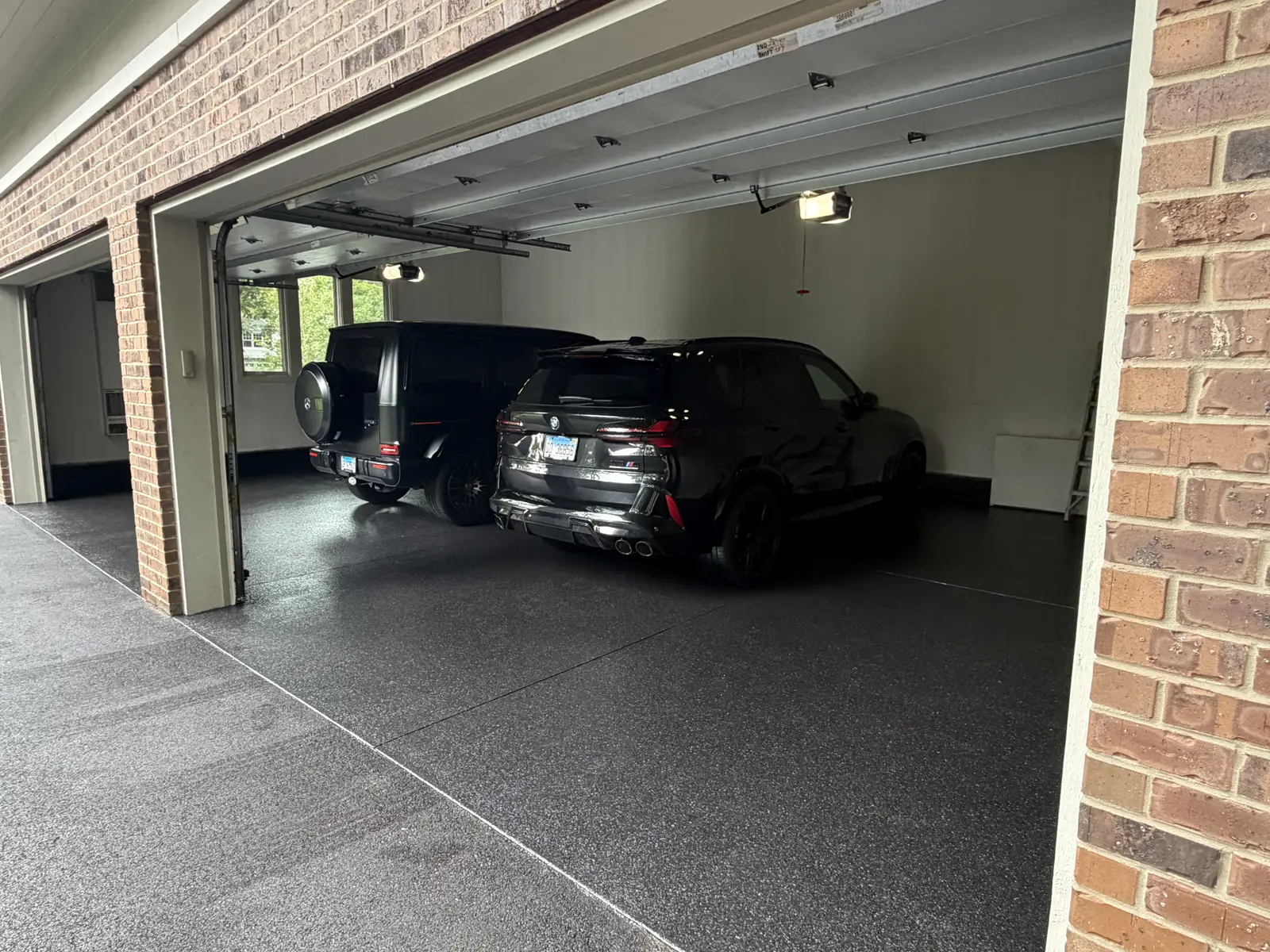 SUVs parked on a grey flake coated garage floor